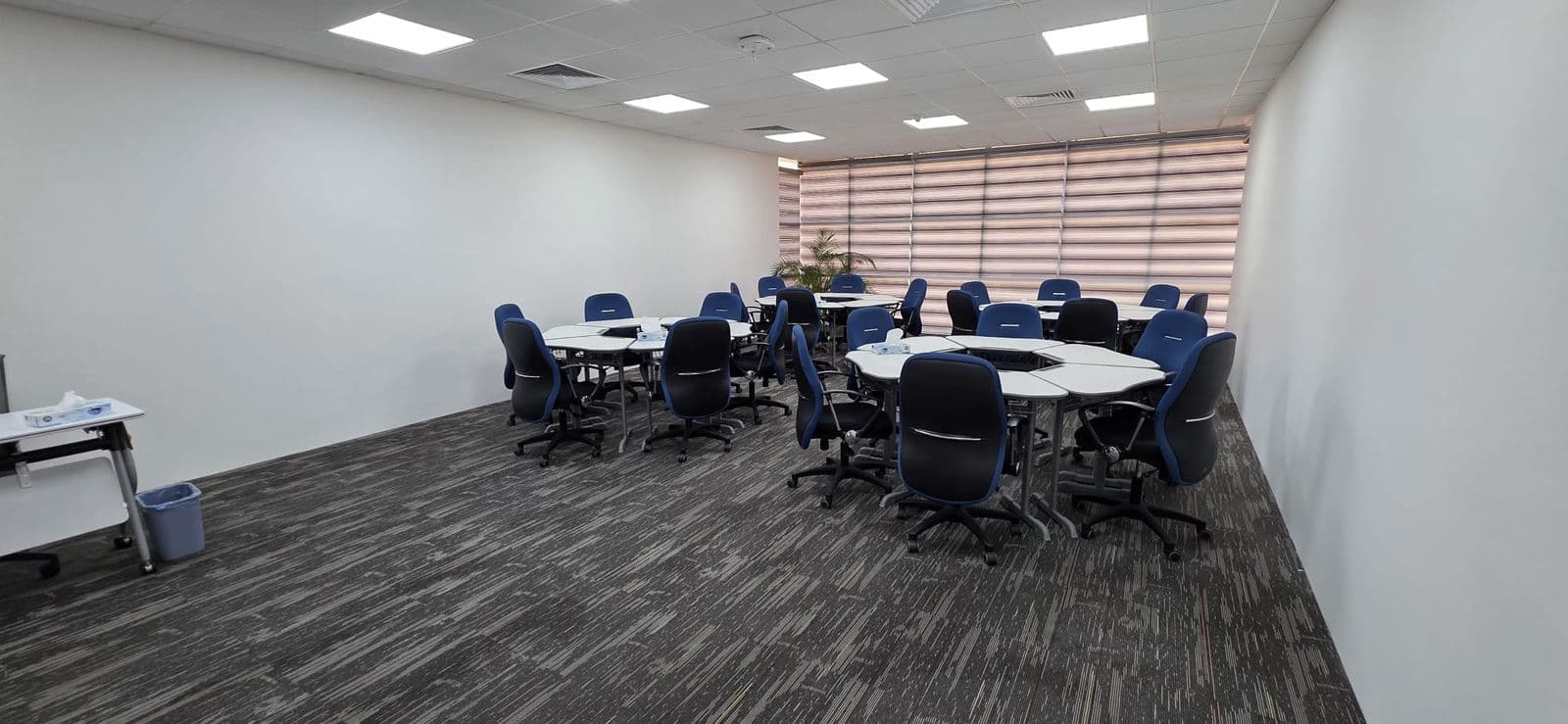 A syndicate room with round tables for small-group exercises.