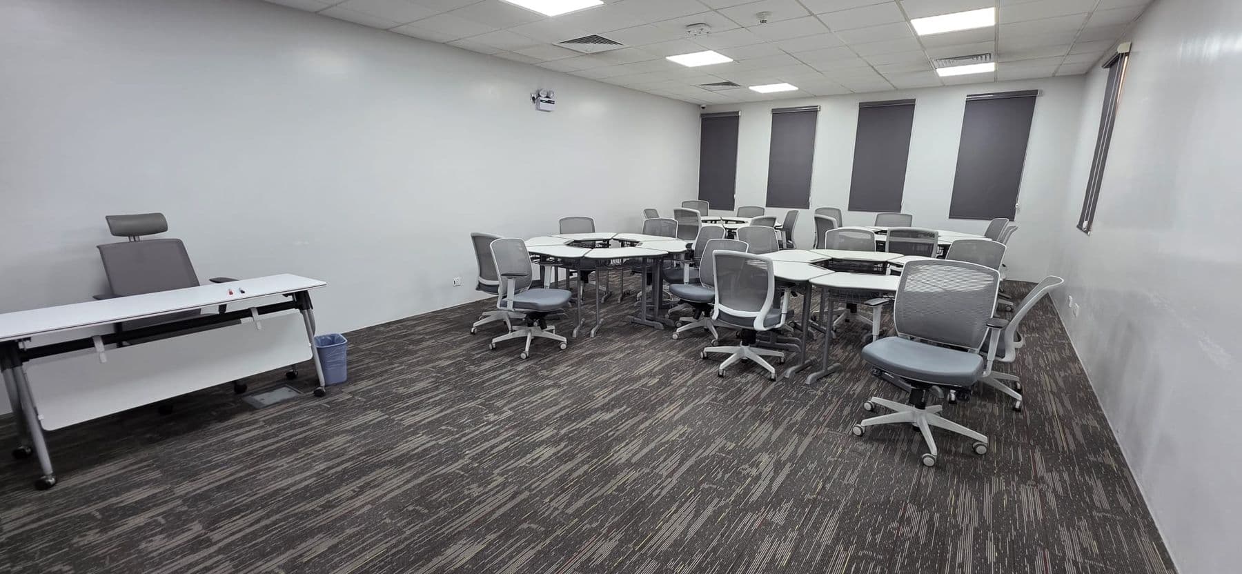 A classroom laid out with round tables and workstations for group work.