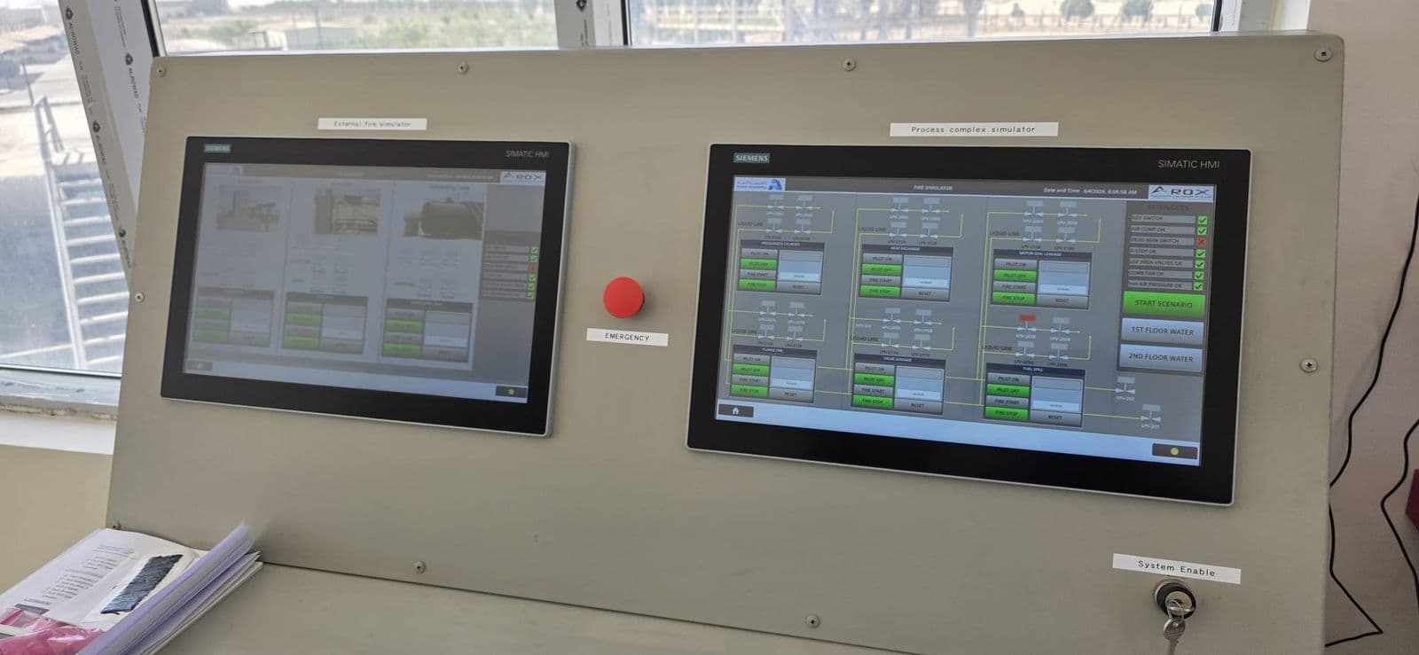 The control station: two operator screens facing the windows that overlook the fire ground.